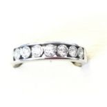 A 9ct white gold half eternity ring, having open band set with seven ribbed framed diamonds -