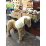 A large childs battery powered pony; and a collection of soft toys - bears, animals, penguins, dogs,