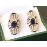 A pair of 9ct white gold deco Egyptian revival style earrings, the panels bezel set with oval