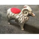 A novelty silver pin cushion modelled as a ram with scrolled horns, the back with inset cushion -