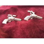 A pair of sterling silver cufflinks modelled as revolvers with mother-of-pearl handles. (1.25in) (