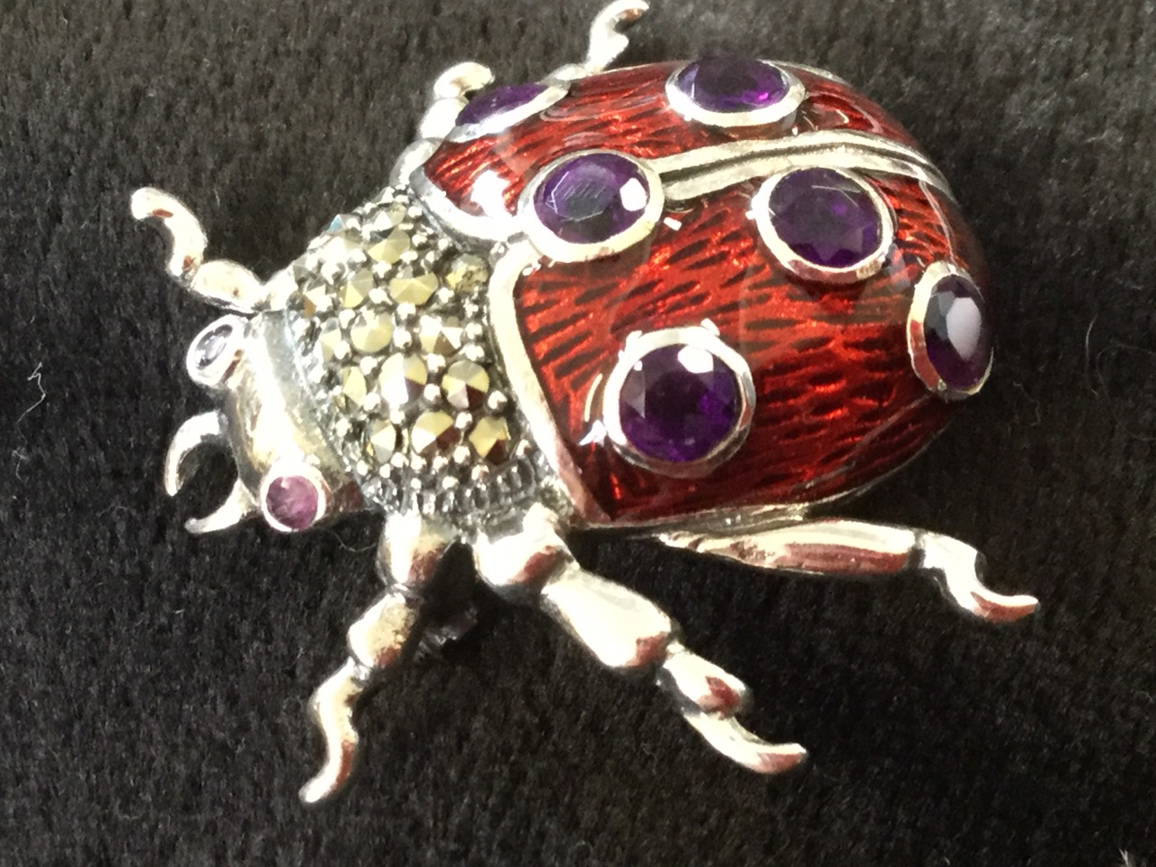 A silver ladybird brooch, the enamelled back set with amethysts having marcasites to thorax, with - Image 2 of 3