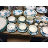 A Minton dinner/tea service embossed with blue ribbons having gilt rims - dinner plates, jugs,