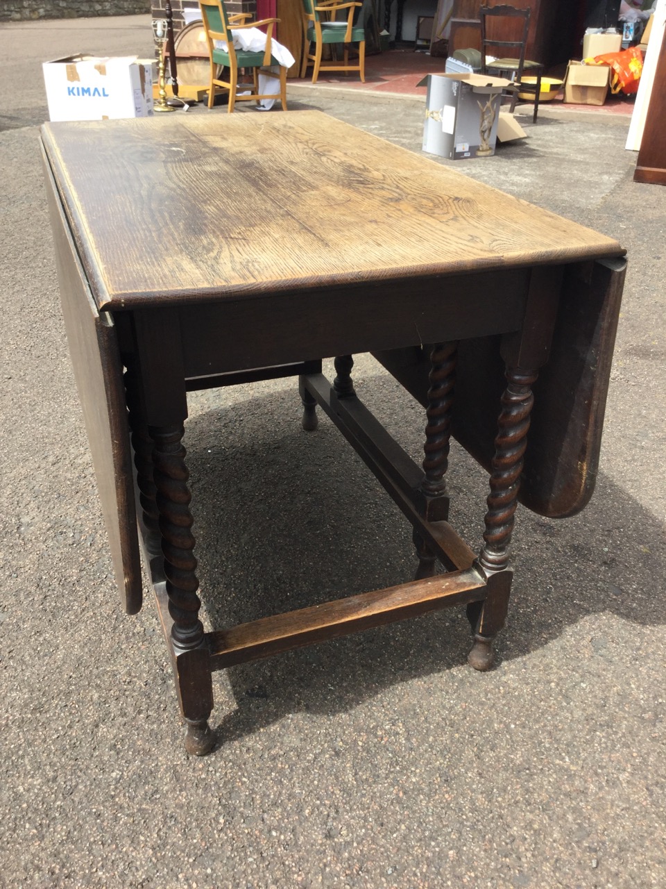 An oak dining table, the rectangular top with rounded drop leaves on barleytwist supports joined - Image 3 of 3