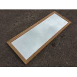 A modern rectangular oak framed mirror with bevelled plate. (19in x 51in)