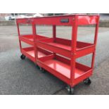 A pair of Senator workshop trolleys, each with three rectangular trays, raised on casters with