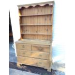 A ‘married’ pine dresser, the made-up delft rack with moulded cornice above a shaped apron having