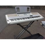 A Yamaha keyboard, the Portable Grand model DGX 300 with five octave keyboard, over 200 effects,