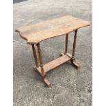 A rectangular scalloped top Victorian occasional table, raised on twin baluster turned columns