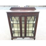 A stained glazed china cabinet with shaped upstand to rectangular moulded top, having gothic