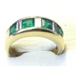 An 18ct gold Asprey emerald & diamond ring, the bezel set emeralds alternating with baguette cut