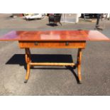 A reproduction yew sofa table, the crossbanded top with ebony stringing above two drawers, having