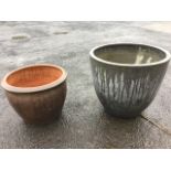 A large terracotta salt glazed garden pot with moulded rim; and a contemporary grey composition