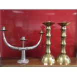 An eastern silver weighted leaf moulded menorah type candelabra with three tapering branches; and