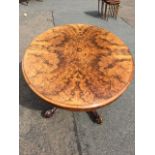 An oval Victorian burr walnut breakfast table, the moulded top above a boxwood strung frieze, raised