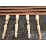 Three lengths of mahogany cornice type moulding; and a set of four turned pine table legs. (7)