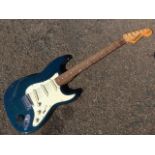 A Tanglewood electric guitar with mother-of-pearl inlay to fingerboard, having blue stained wood