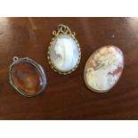 An oval Victorian carved cameo of a lady with scarf in twisted gilt metal mount with scrolled crest;