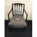 A nineteenth century antique mahogany elbow chair, the back with fluted spindles in gothic frame,