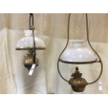 A hanging brass oil lamp with ribbed reservoir, the Hinks burner converted to electricity, having