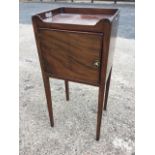 A Georgian mahogany nightstand with tray top above a cockbeaded cupboard, raised on square moulded