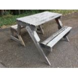 A garden table & bench set, the folding piece with slatted tabletop framed by plank seats on
