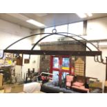 A rectangular wrought iron kitchen hanger, the domed frame with crossed bars beneath ring, mounted