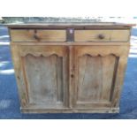 A Victorian pine press cupboard with later alterations, having two knobbed frieze drawers above a