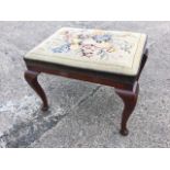 A large mahogany stool with rectangular needlework seat raised on cabriole legs with pad feet. (26in