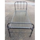 A Victorian 3ft iron bed with rounded tubular head & tailboard, having vertical bars to top,