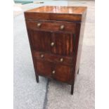 A Georgian mahogany washstand, the twin tray top revealing a surface pieced for bowls above a