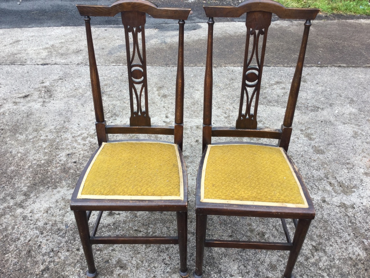 A pair of art nouveau side chairs, the backs with crook rails above fretwork pierced splats, the