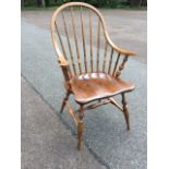 A nineteenth century style windsor armchair with hooped back on spindles with downswept shaped arms,