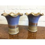 A pair of Gill Pemberton Denby stoneware vases with rippled flared rims above tubular ribbed bodies.