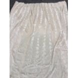 A cream coloured lined and pleated faux-fur curtain. (88in)