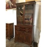 A Georgian mahogany secretaire bookcase, the moulded cornice above astragal glazed doors enclosing