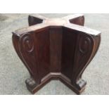 A nineteenth century mahogany table base of quatrefoil panelled form, with scroll carved cushion