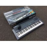 A boxed Yamaha PSR 19 Portatone electronic keyboard, the five octave instrument with 99 effects,