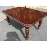 A reproduction Victorian style mahogany dining table, the rectangular moulded top with rounded