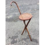 An Austrian Edwardian Thonet walking stick seat, the bentwood walking cane folding into a circular