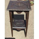 A Victorian carved table, the square top with thistle type floral medallion in panel having leaf