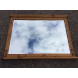 A rectangular pine overmantel mirror, with moulded cornice and ribbed pilasters, the plate bevelled.