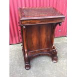 A nineteenth century rosewood davenport, the desk with inset writing surface enclosing a satinwood