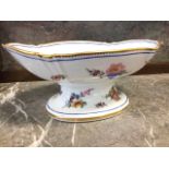 A nineteenth century Sêvres porcelain fruit dish, the scalloped oval bowl painted with polychrome