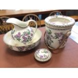 A Wedgwood jug & basin set with slop pail and soapdish & cover, all decorated with purple flowers