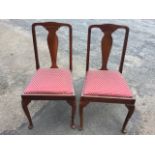 A pair of Queen Anne style side chairs with vase shaped splats above drop-in upholstered seats,