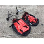 A pair of waterproof cyclists panniers; and two bicycle racks with fittings. (4)