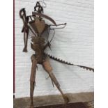 Lorna Logan, a wrought iron figural sculpture, the robotic-like man made from agricultural tools and