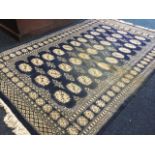 An oriental rug woven with panel of thirty-three oval medallions in blue field framed by