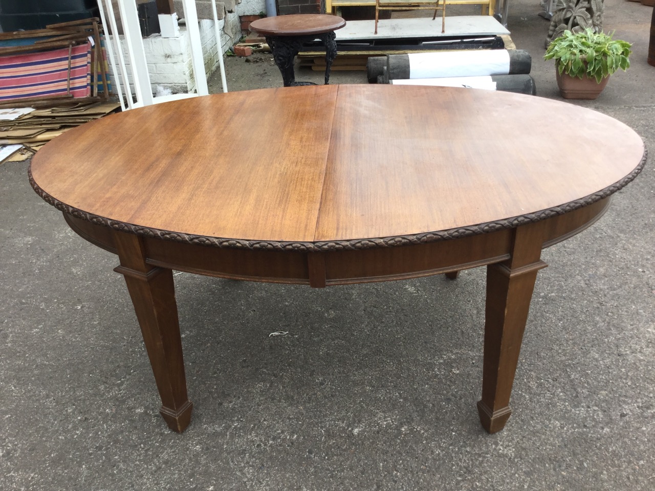 A late Victorian mahogany dining table, the oval top with flowerhead carved edge above a plain - Image 2 of 3